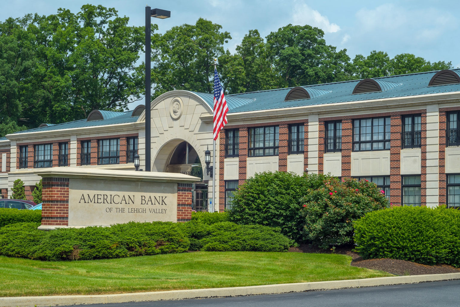 American Bank of the Lehigh Valley branch building with American flag