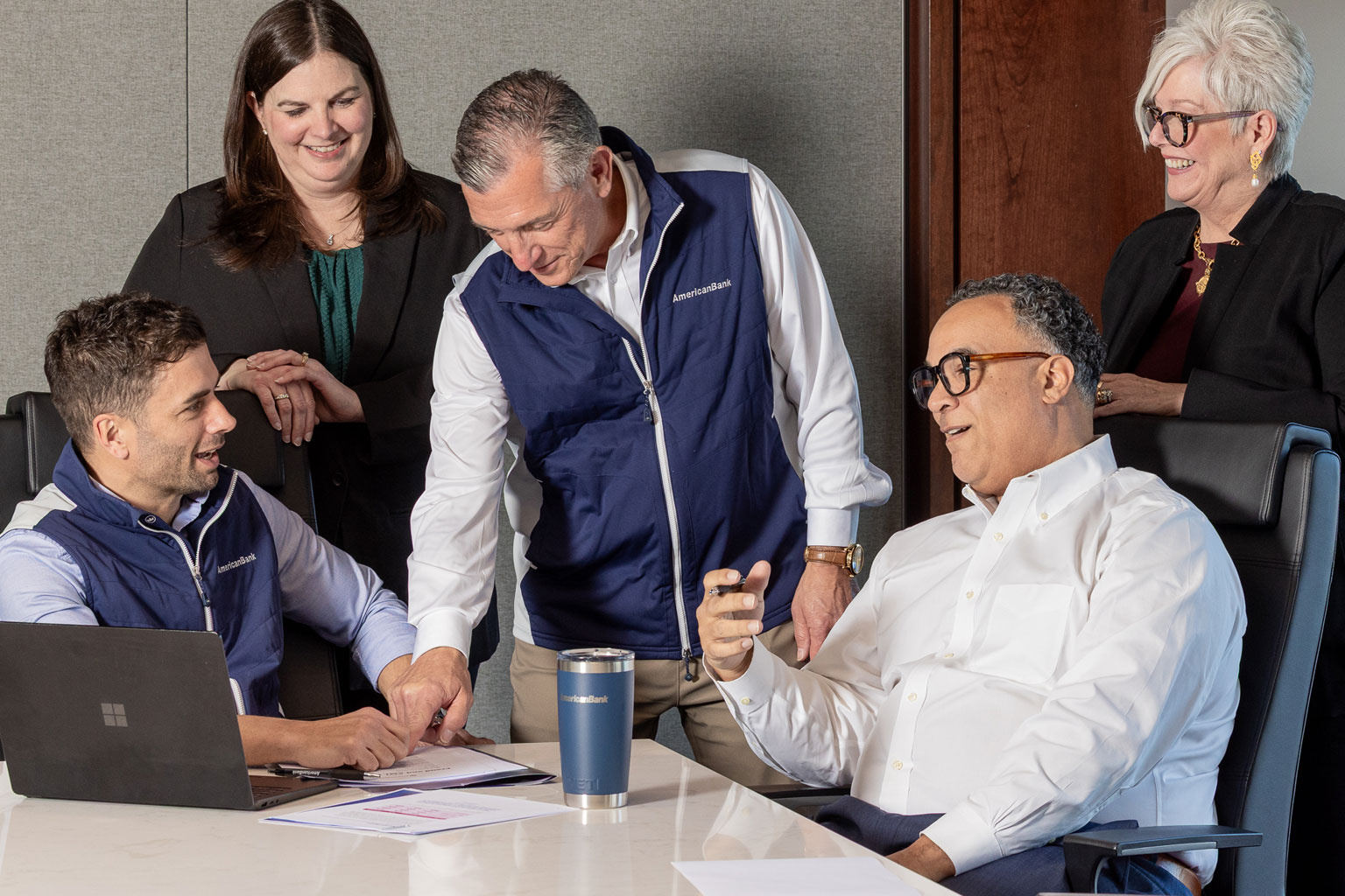 The American Bank commercial lending team collaborating around a table