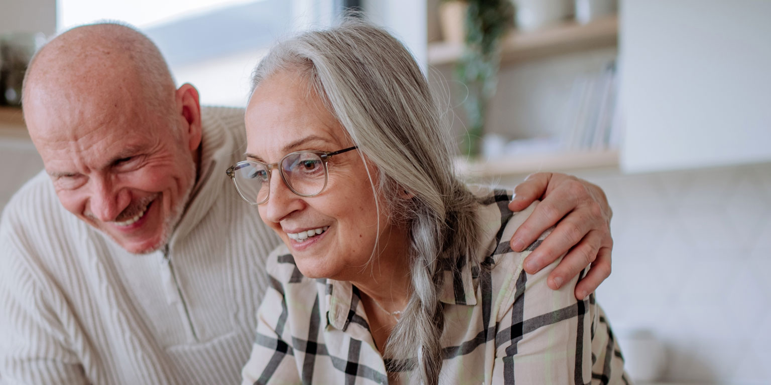 An older couple reviewing finances on a laptop