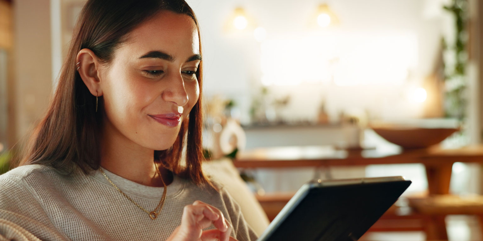A woman using a tablet at home