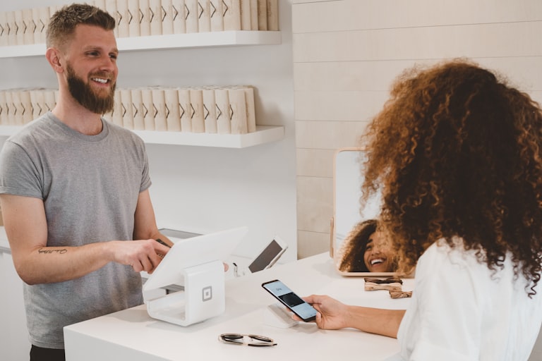 Customer paying by phone at a retail counter