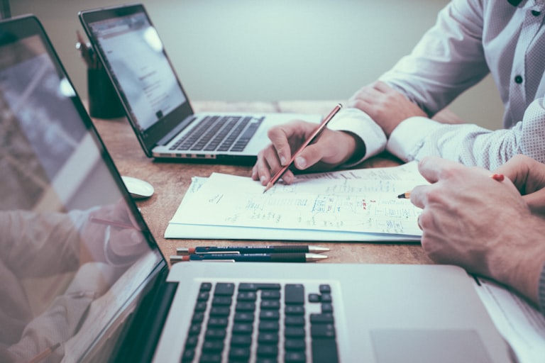 Professionals reviewing documents at a desk